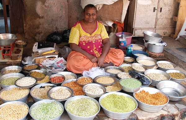 Woman selling pulses at Mumbai, India market.
