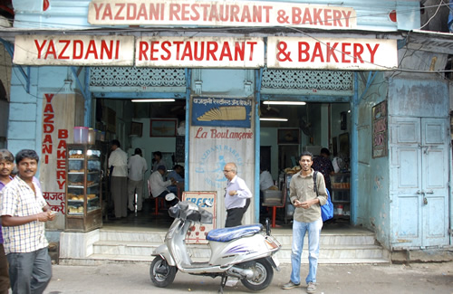 Rehan and scooter in front of legendary 'Yazdani Bakery' in Mumbai.