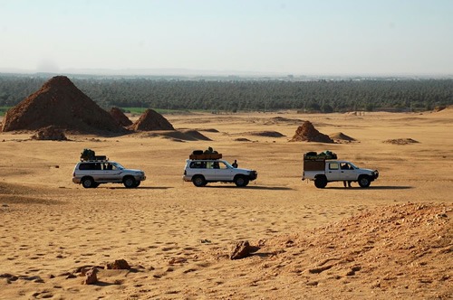 Car convoy through North Sudan desert.