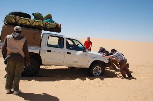 Car stuck in desert sand.