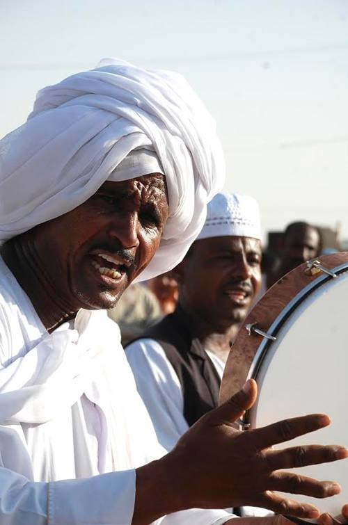 Sufi men playing music and singing in Sudan.