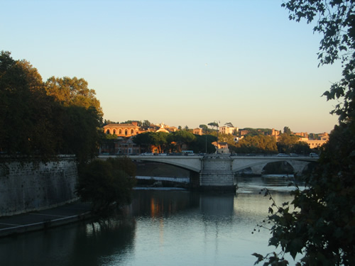 Standing on a bridge looking down the Arno River in Rome at sunset makes for great siteseeing.