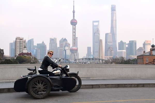 The author cruising Shanghai driving a vintage motor cycle.