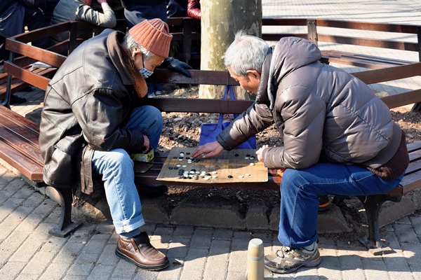 Men playing chess in the park in Shanghai.