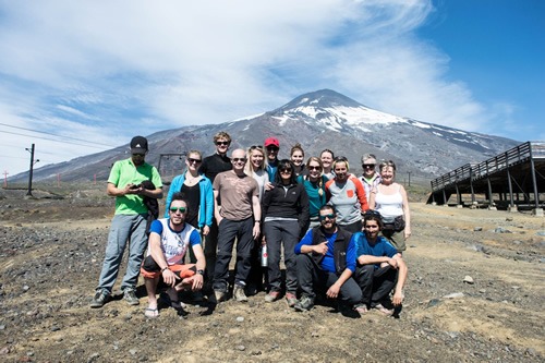 Small group travel: Team photo after scaling Volcano Villarrica in Chile.