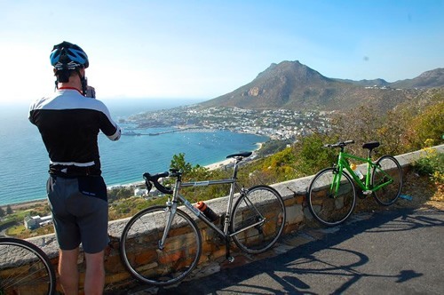 Cyclist taking photos of Cape Town, South Africa on a group tour.