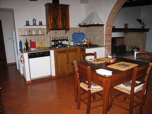 Eating and drinking wine in Italy is enjoyable in a rental home with a kitchen and table.