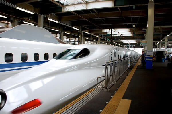 A train station in Japan with white bullet trains, which is how I sometimes traveled.