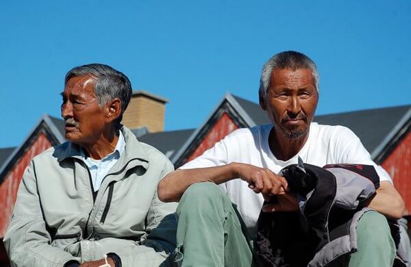 Local men are relaxing in a fishing village in Greenland.