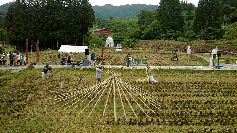 A dancer performs in rice field at festival in Toyomi, Japan.