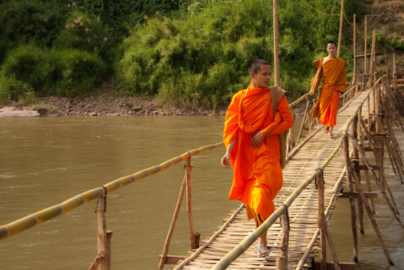Monks crossing a bridge in Laos.