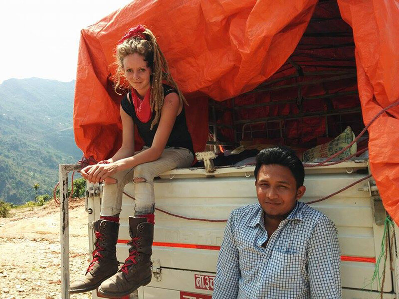 Nepal, Gorkha, vehicle driver and author sitting on back of truck.
