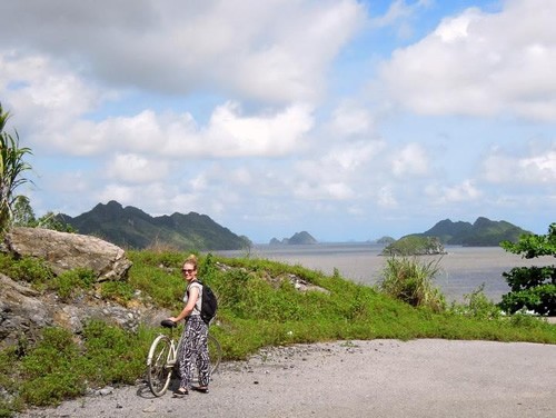 The author cycling amidst beautiful landscapes in Cat Ba Island