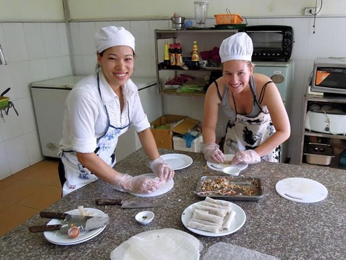 Author practicing rolling spring rolls before frying them at Cat Ba Island.