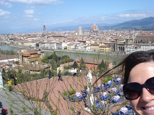 Au pair on hill looking over the skyline of Florence, Italy.