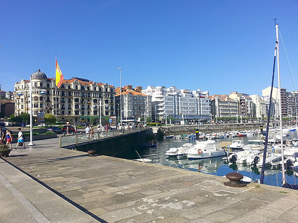 Work as an au pair in Santander, Spain, a city featuring boats moored in the bay.