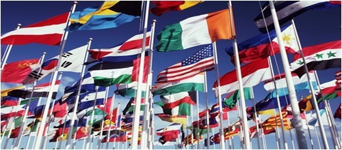 International flags waving in the wind, with teaching schools available worldwide.