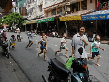 Kids running in Hanoi.
