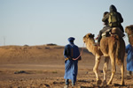 Riding camels in Morocco.