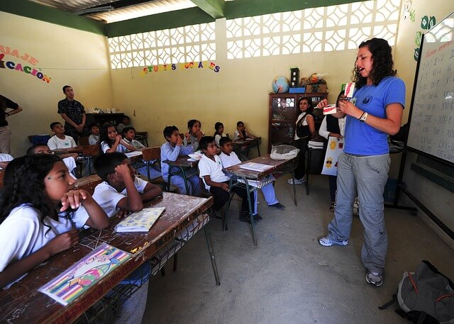 Woman teaching a high school class abroad.