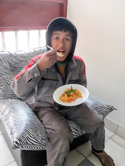 Bolivian child eating lunch.