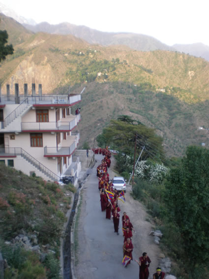 Monks pass by the school.