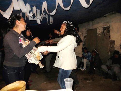 Women dancing at a High school graduation celebration in Bolivia.