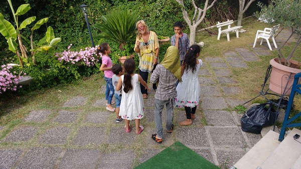 The author leading Syrian children in a singing game on Samos, Greece.