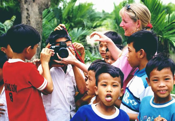 Showing children in Vietnam how to take photos.