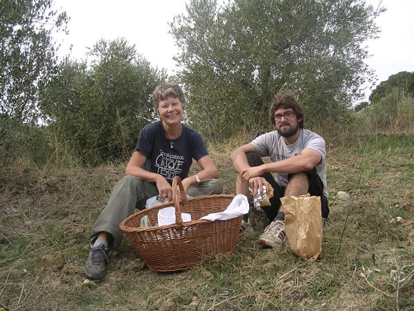 The author and friend volunteering in olive grove with WWOOF in Italy.
