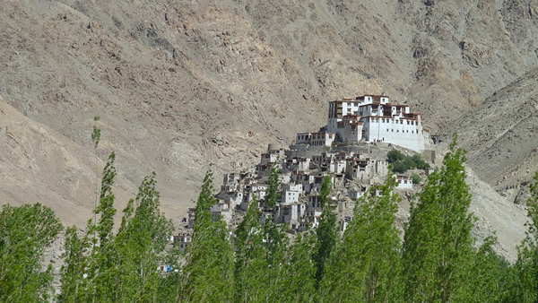 View of the beautiful white town of Ladakh, Nepal nestled in the mountains atop a hill.