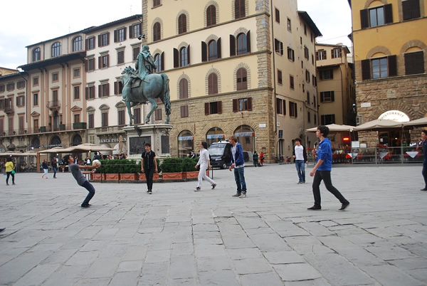 Street scene of children playing at a square in Florence, Italy.