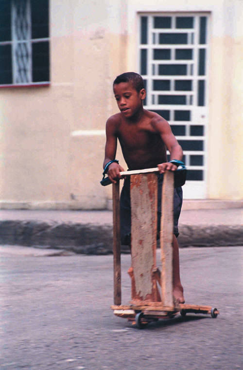 Photo of child riding home-made scooter in Cuba