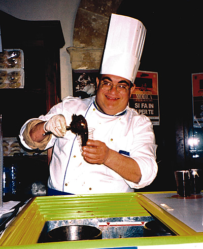 Man scooping gelato in Sicily.
