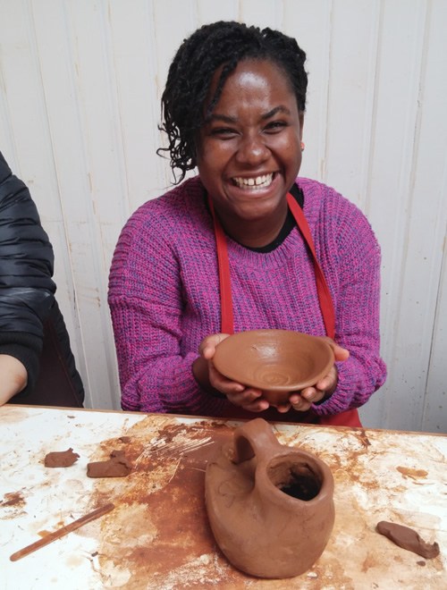 The author smiling during her pottery class Pomaire, Chile.