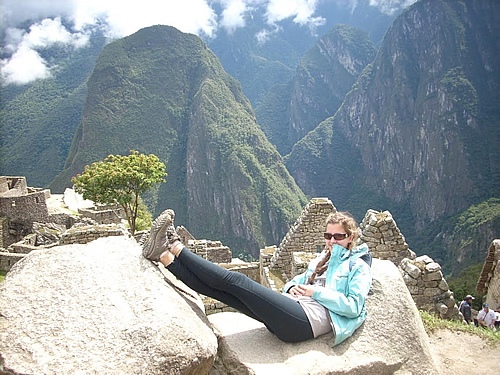 Author sitting in the midst of Machu Picchu ruins.