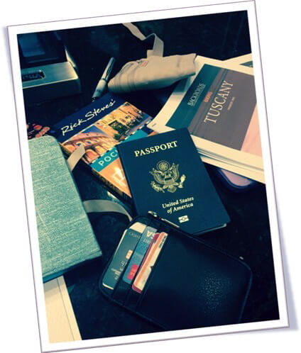 Preparation for a trip to Rome, Italy, with passports, guidebooks, and credit and ATM cards/