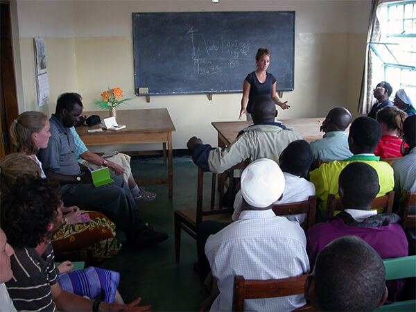 Author presenting research to students in a classroom in Tanzania.