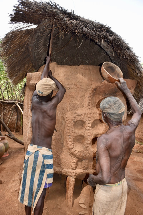 Dupa chief fetching millet from the central granary