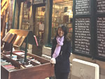 Woman teacher at bookstore in France.