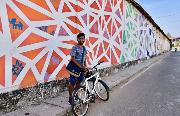 Guide Prajwal at mural in Fort Kochi