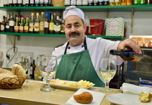 Sharing petiscos and wine in a family-owned petisqueira in Lisbon.