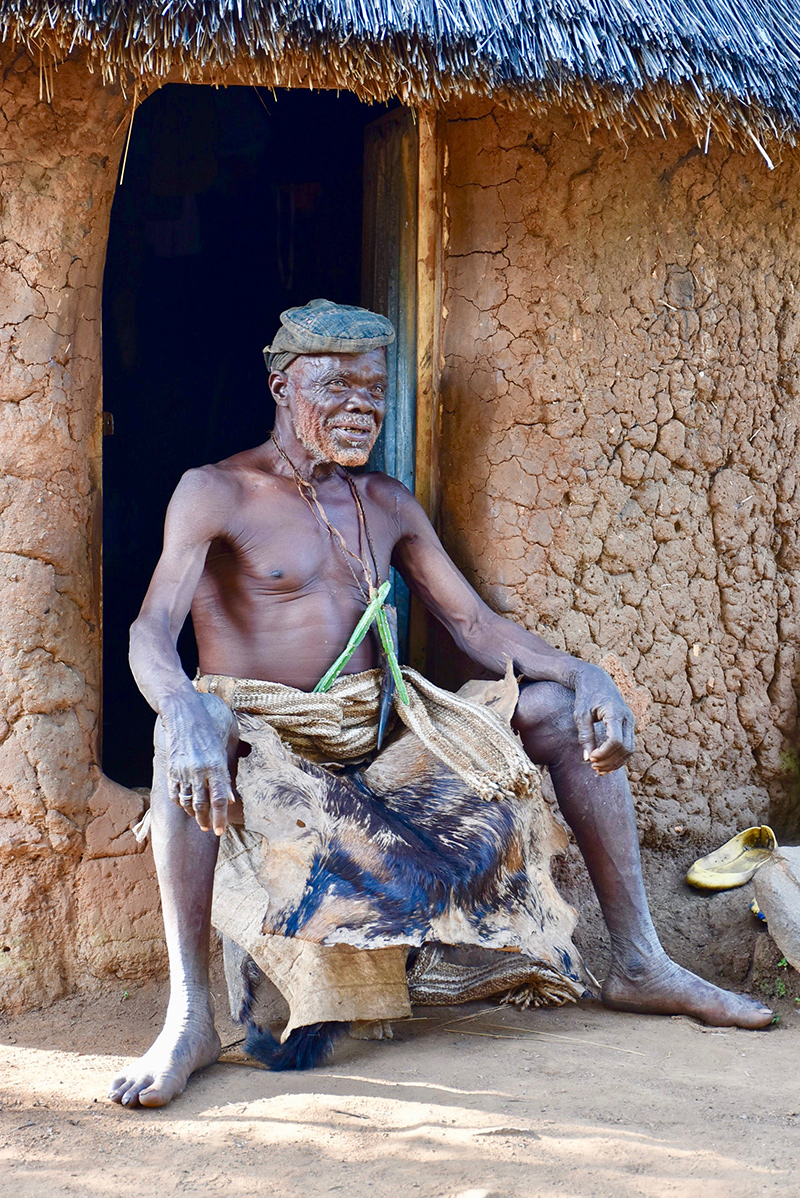 Old man sitting on stoop in Cameroon