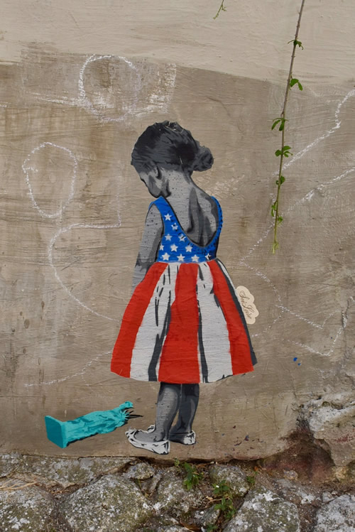 Urban street art in Porto. Image of girl looking at fallen Statue of Liberty.