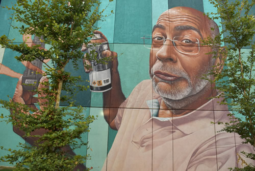 Urban street art in Porto, Portugal. Self-portrait of a man spray painting.