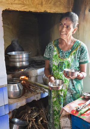 Hostess in her kitchen baking dosas