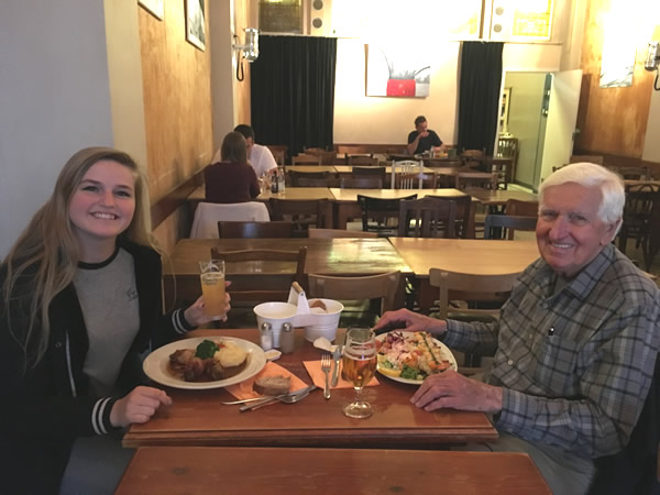 Grandfather John with granddaughter Sutton enjoying dinner in Brussels