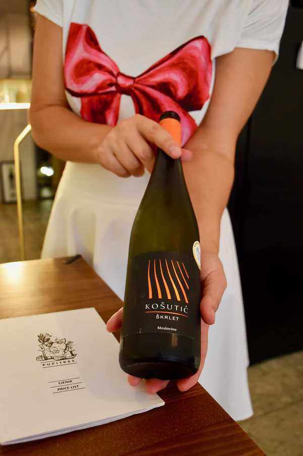 Jelena from wine boutique 'Pupitre' shows a bottle of her excellent Croatian wine selection.