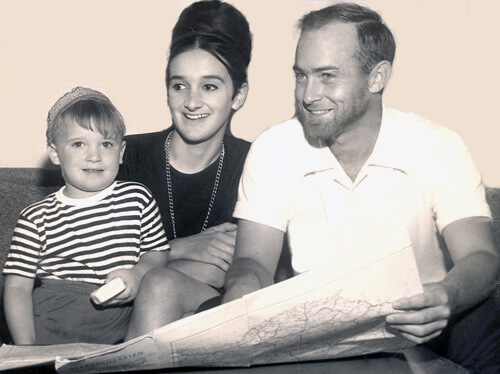 Clay Hubbs with his wife and son showing a map of a journey in 1963.