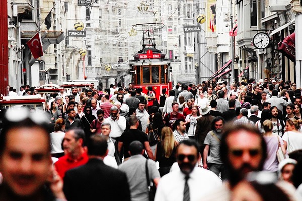 A busy street scene in the city with a tram.